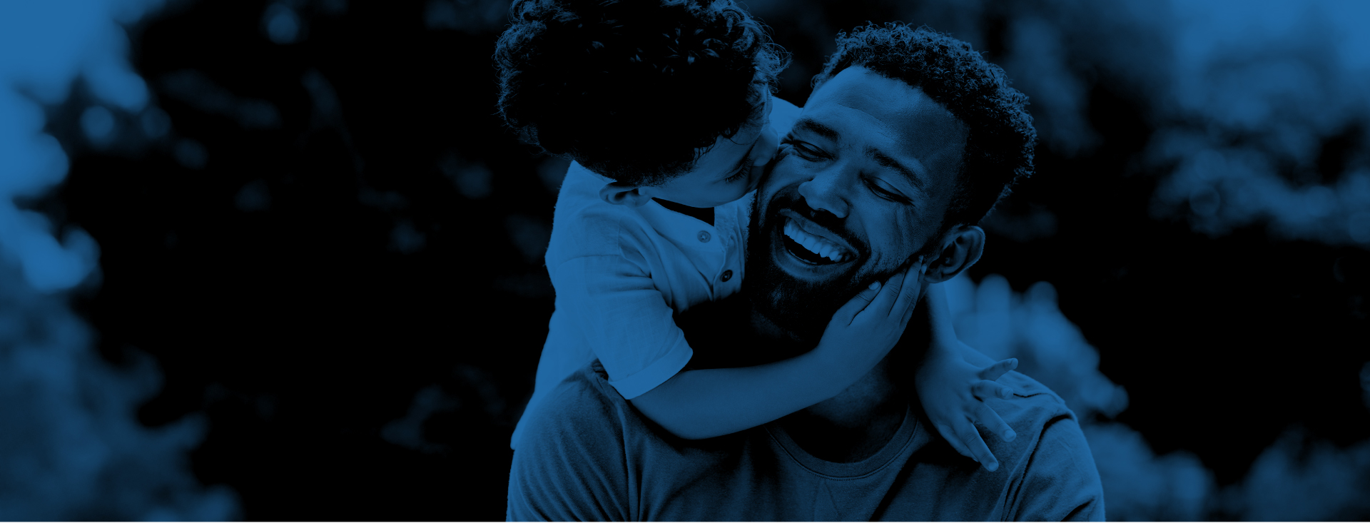 A young child has their arms wrapped around their smiling parent and is kissing their cheek; a blue overlay is on the photo