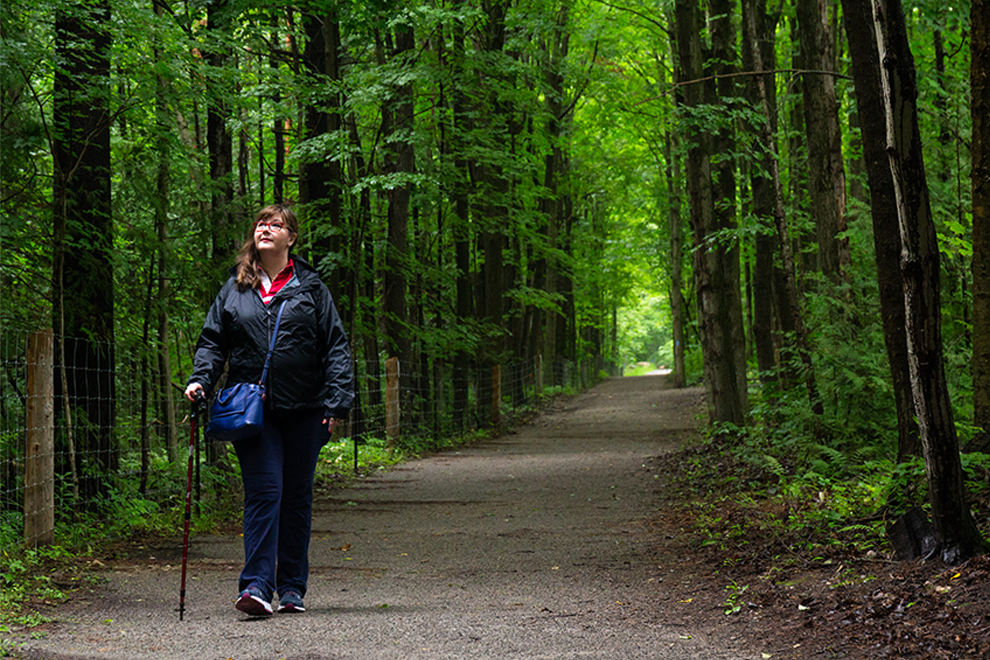 Adult walking on a groomed trail in the forest