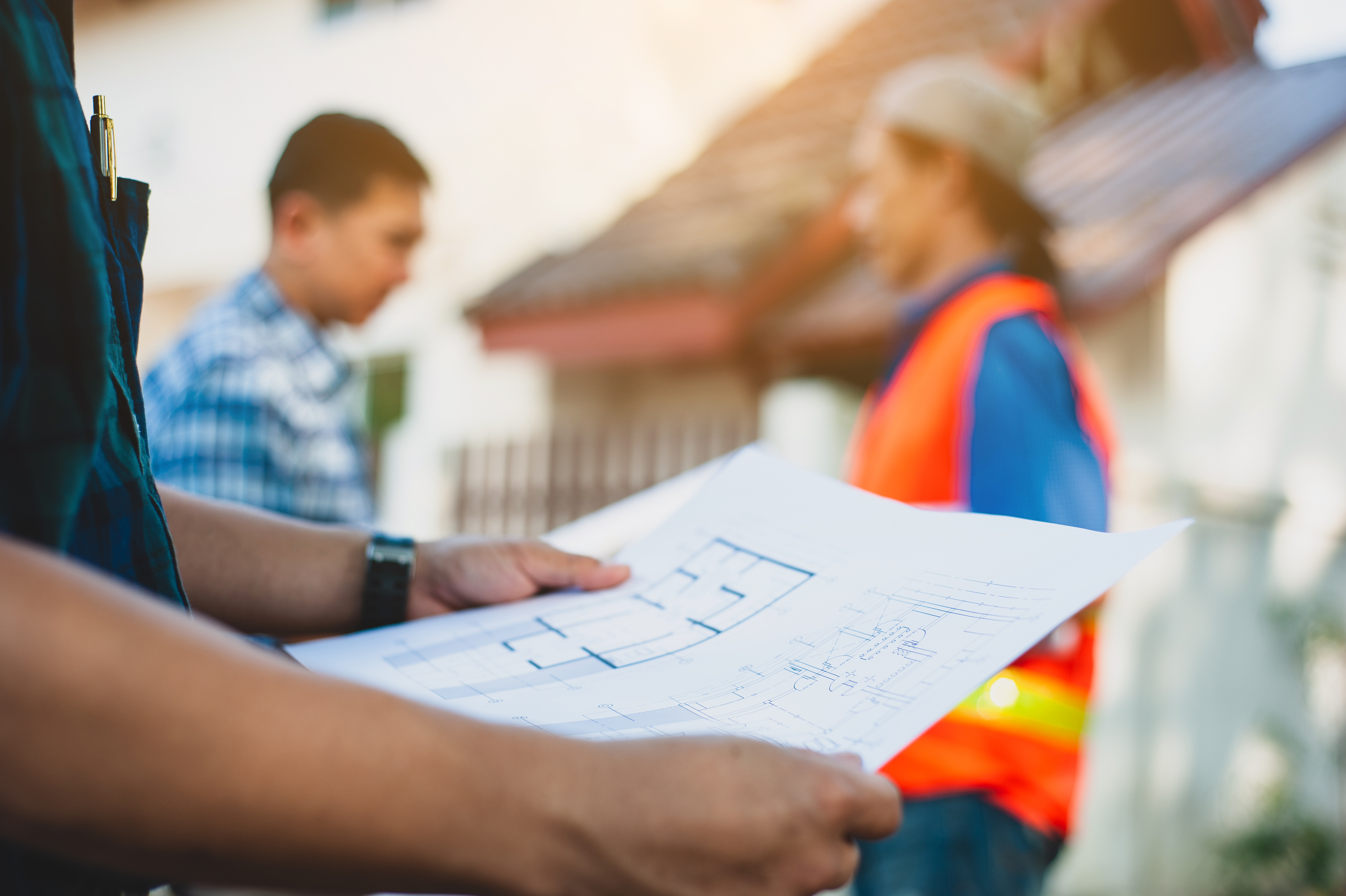 Contractor holding a construction project plan.