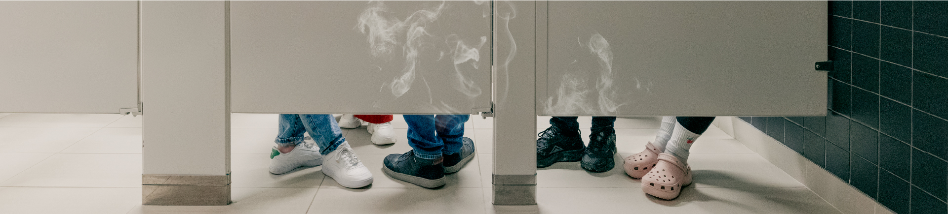 shoes in a bathroom stall with smoke