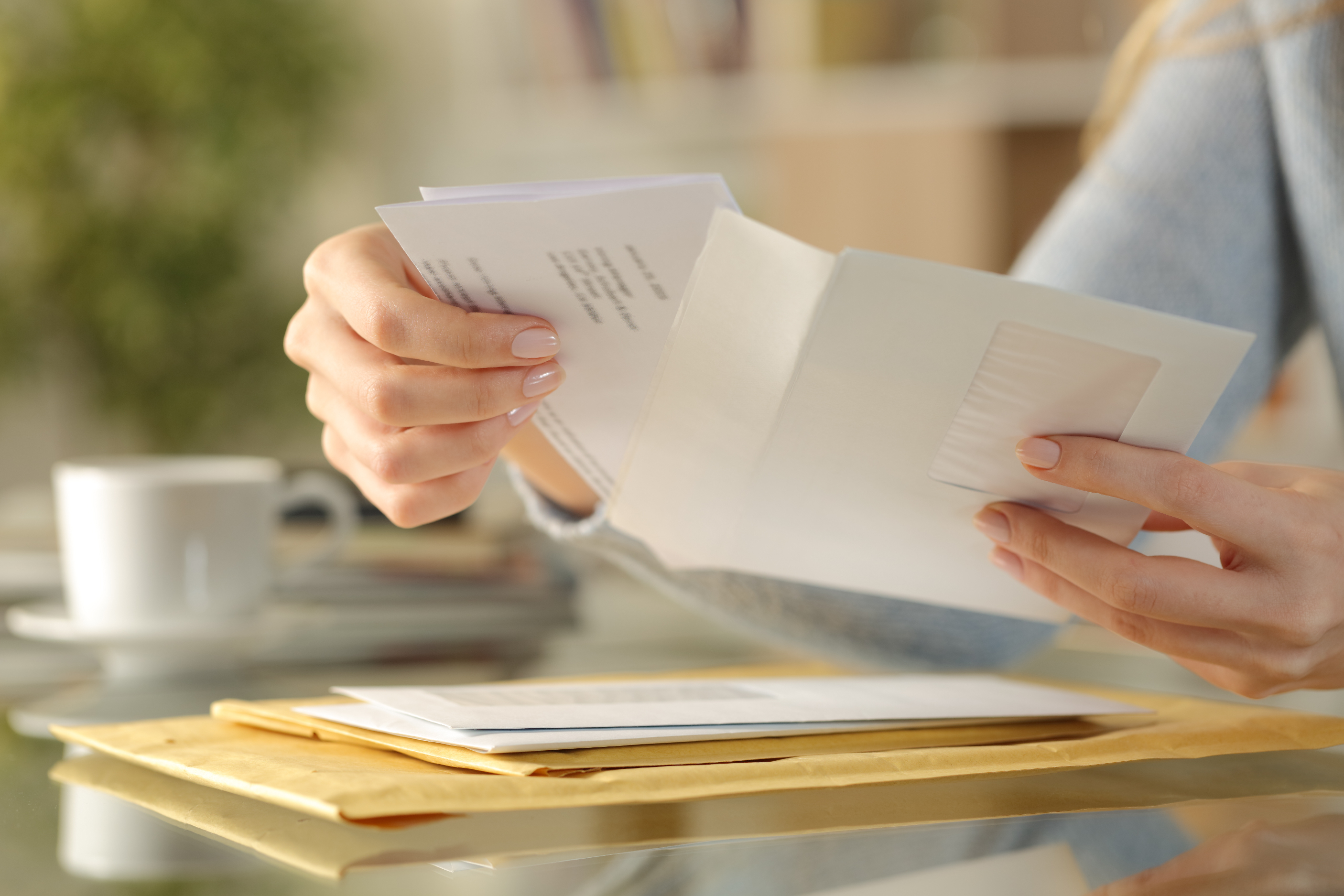 Image of a set of hands reading a letter.