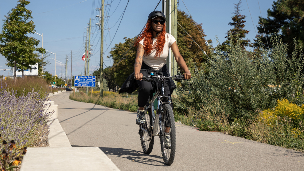 female cyclist riding a bike on a protected bike lane