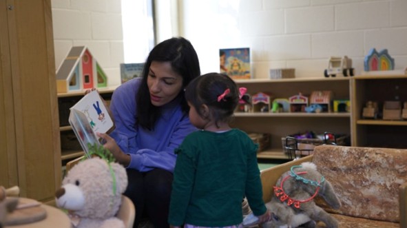 woman reading to child in EarlyOn centre