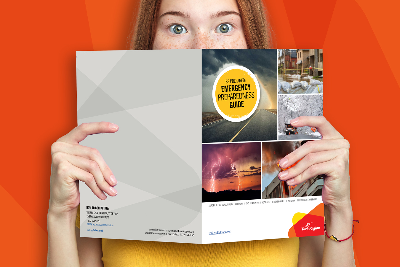 a young adult looking through the York Region emergency preparedness guide
