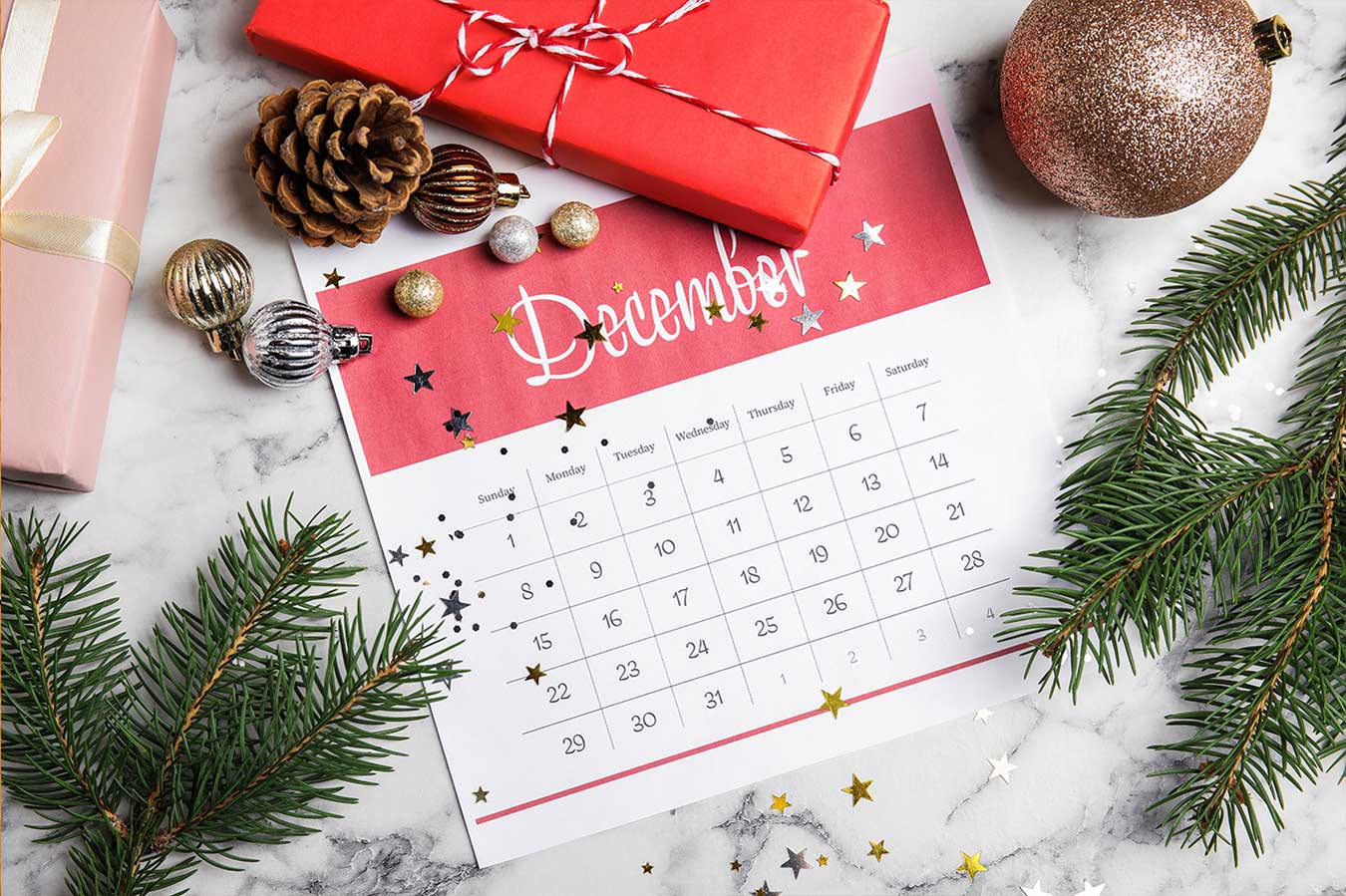 December 2024 calendar surrounded by pine branches
