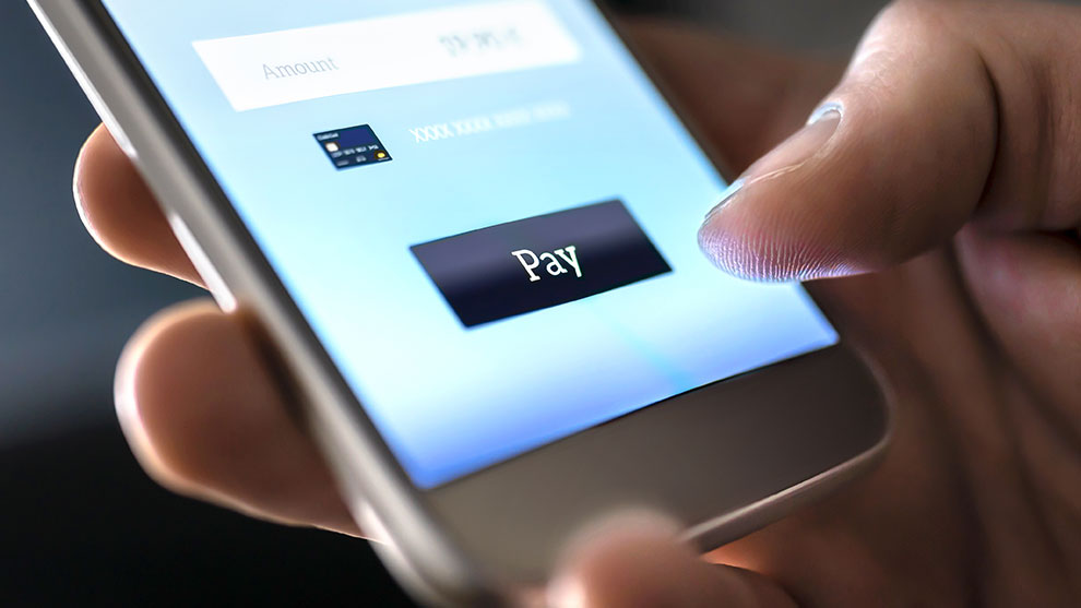 close up of hand holding a smart phone with Pay button