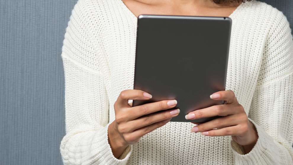 Female viewing a remote trial on a tablet