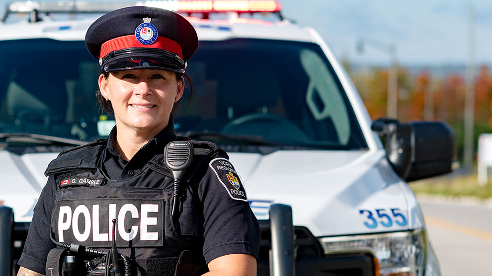 Female officer next to a police car