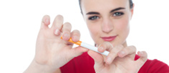 A young woman breaking a cigarette